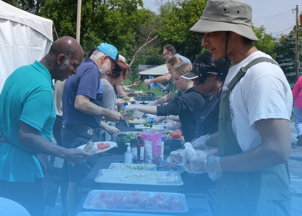 People in line for food at summer picnic