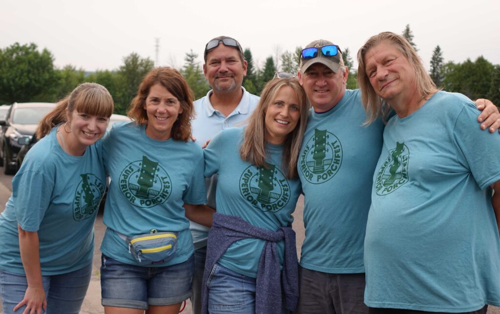 Groups in blue tshirts posing for picture