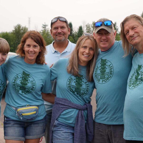 Groups in blue tshirts posing for picture